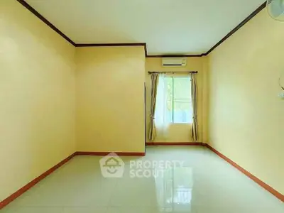 Spacious empty room with air conditioning and large window, perfect for customization.