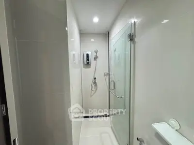 Modern bathroom with glass shower enclosure and sleek fixtures