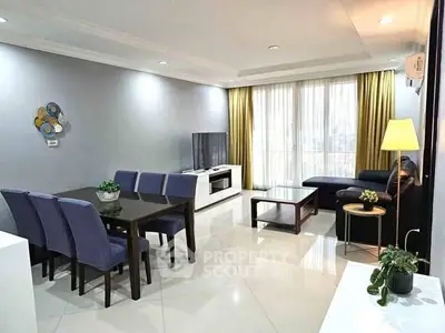 Spacious living room with modern decor and ample natural light.