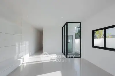 Spacious modern interior with sleek design and large windows for natural light.