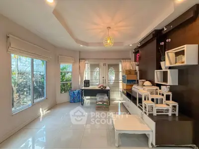 Spacious living room with modern decor and large windows for natural light.