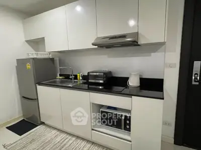 Modern kitchen with sleek white cabinets and appliances