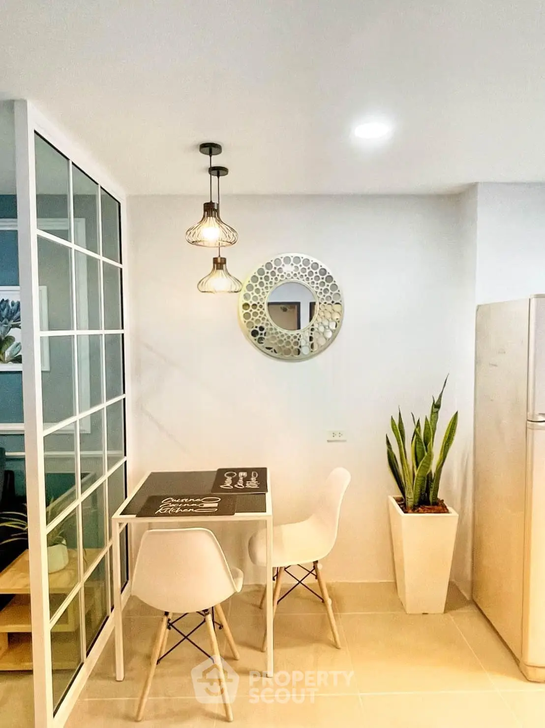 Chic dining nook with modern decor and stylish lighting in a cozy apartment setting.