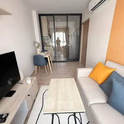 Modern living room with open layout and stylish decor, featuring a cozy sofa and dining area.