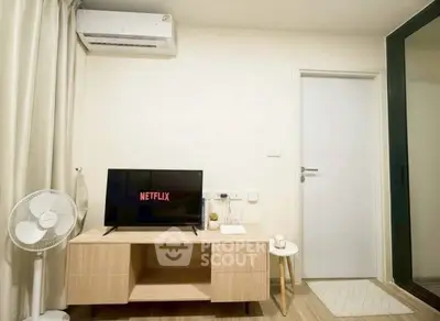 Modern living room with air conditioning and stylish TV setup, perfect for cozy entertainment nights.