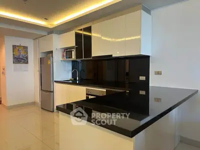 Modern kitchen with sleek black countertops and stainless steel appliances