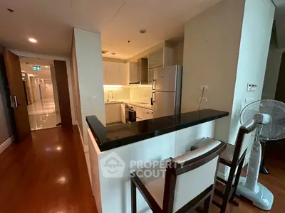 Modern kitchen with sleek black countertop and open layout in stylish apartment