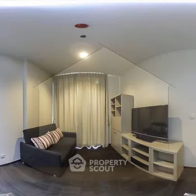 Modern living room with sleek furniture and large TV, perfect for relaxation.