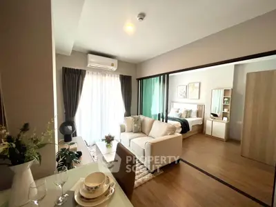 Modern open-plan living room with cozy bedroom in stylish apartment