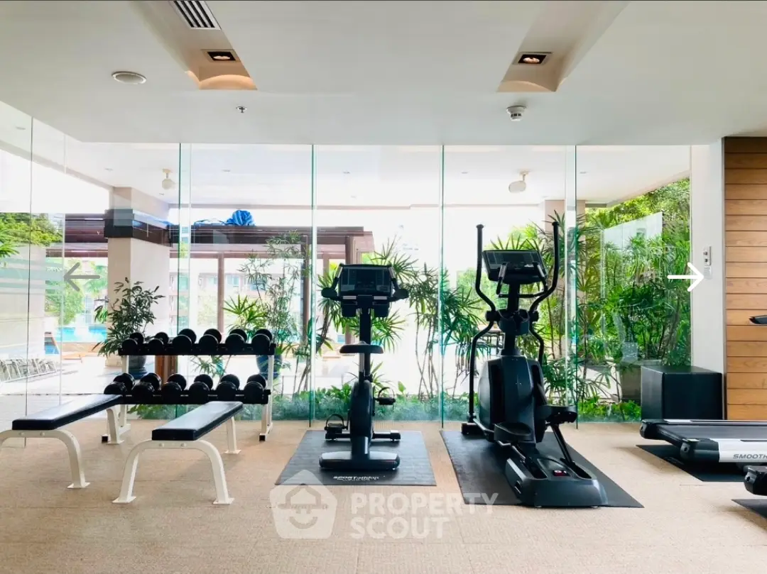 Luxurious gym with modern equipment and pool view in upscale property.