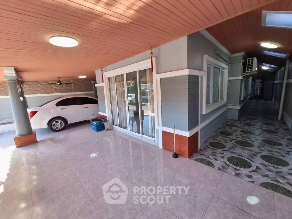 Spacious covered parking area with modern design and elegant tiled flooring.