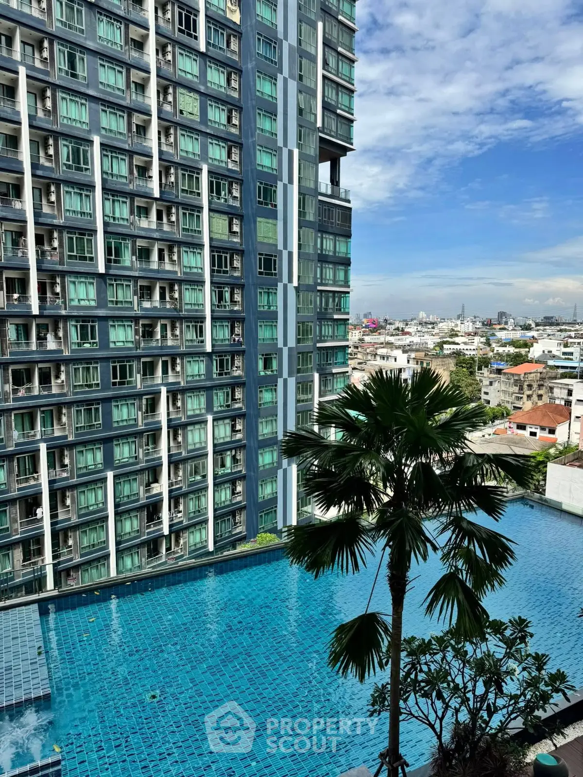 Luxurious high-rise building with stunning pool and city view