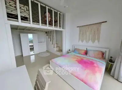 Chic bedroom with loft space and colorful bedding in modern apartment