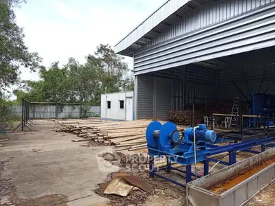 Industrial warehouse exterior with open space and machinery