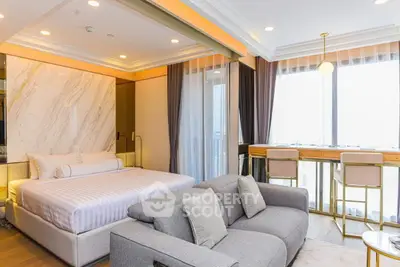 Luxurious bedroom with modern decor and large windows offering natural light