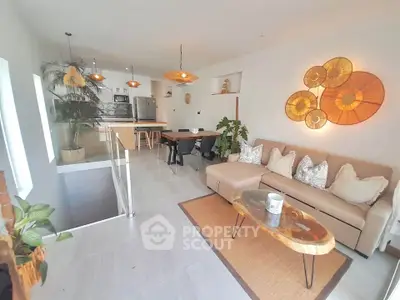 Modern open-concept living room with stylish decor and natural lighting