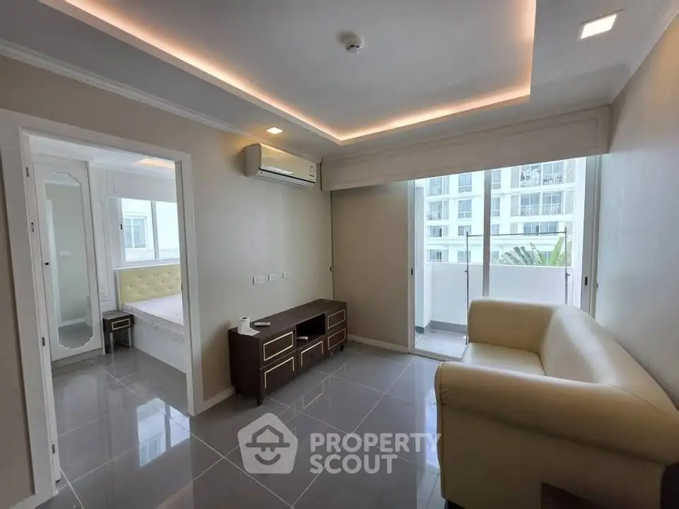 Modern living room with sleek design and balcony view in a stylish apartment.