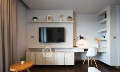 Modern living room with sleek TV setup and stylish workspace