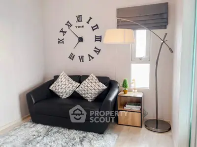 Cozy living room with modern sofa, stylish floor lamp, and decorative wall clock