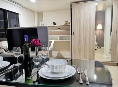 Modern dining area with elegant table setting and cozy living space in background