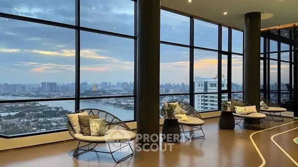 Luxurious high-rise building with panoramic city and river views from a stylish lounge area.