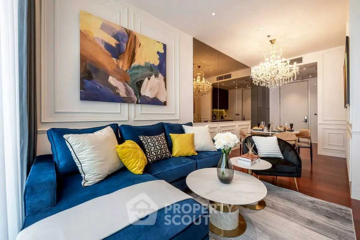 Luxurious living room with elegant decor and plush blue sofa in modern apartment.