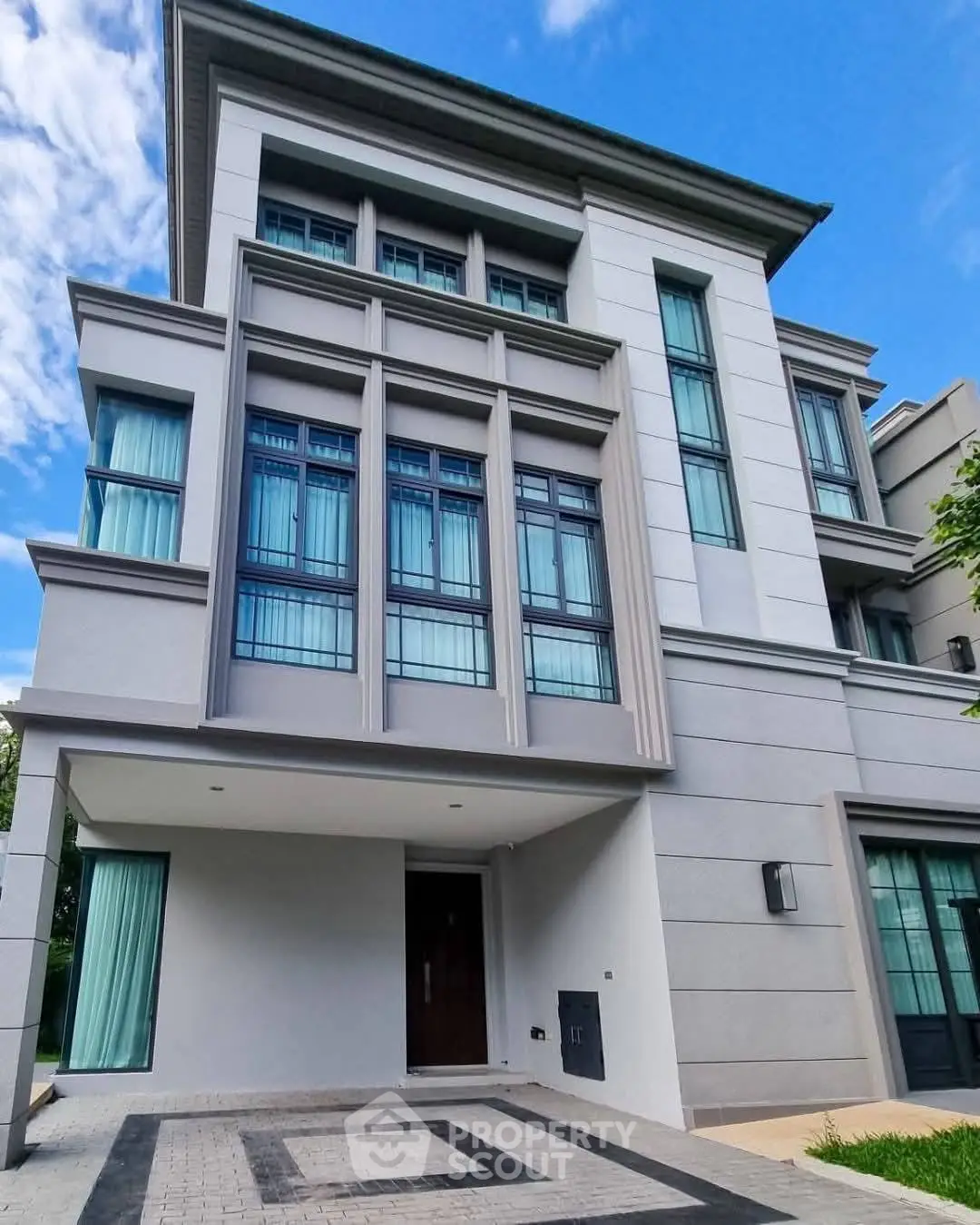 Modern multi-story building with large windows and sleek design