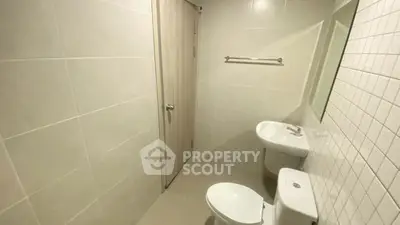 Modern bathroom with sleek fixtures and neutral tiles, perfect for a minimalist design.
