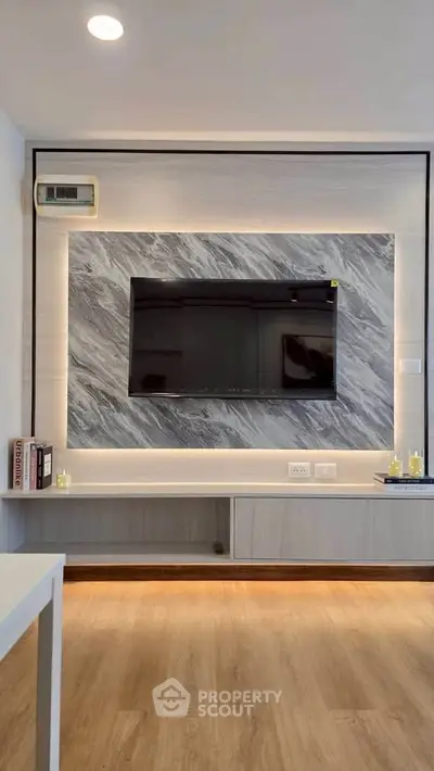 Modern living room with stylish TV wall unit and elegant lighting