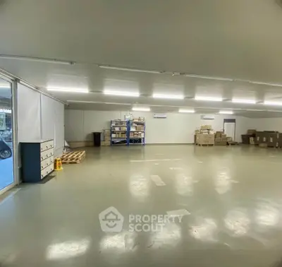 Spacious warehouse interior with ample storage space and bright lighting.