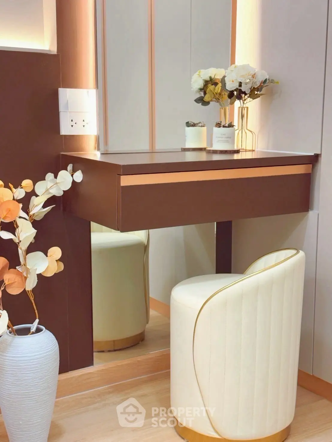 Elegant vanity area with modern design and floral decor in a stylish home interior.
