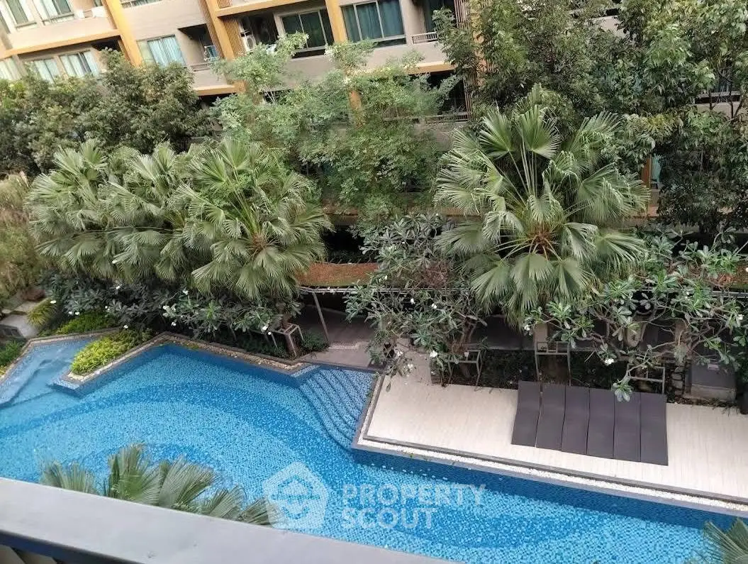 Luxurious residential complex with stunning pool and lush greenery