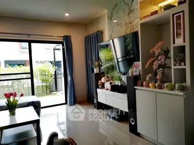 Spacious living room with modern decor and large windows opening to a garden view.