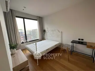 Modern bedroom with large window and minimalist furniture in urban apartment