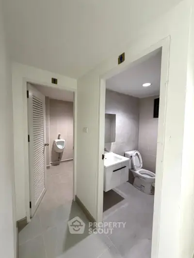 Modern bathroom with separate toilet and urinal in sleek design