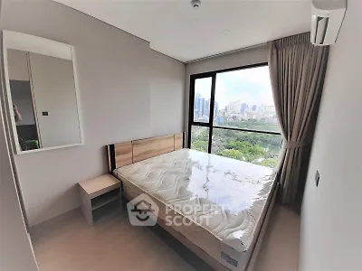Modern bedroom with large window offering stunning cityscape view