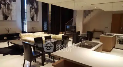 Luxurious open-plan living room with elegant dining area and modern kitchen appliances.