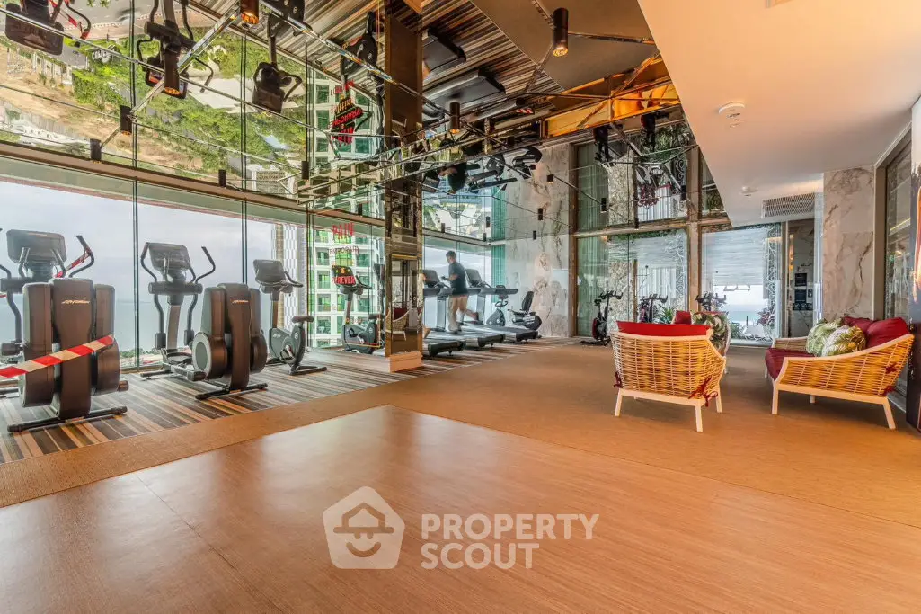 Luxurious gym with modern equipment and stunning views in a high-end residential building.