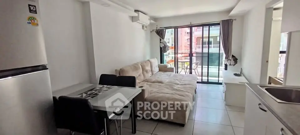 Modern living room with cozy sofa and balcony view in a bright apartment