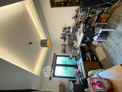 Cozy kitchen with open layout and modern lighting, featuring ample storage and counter space.