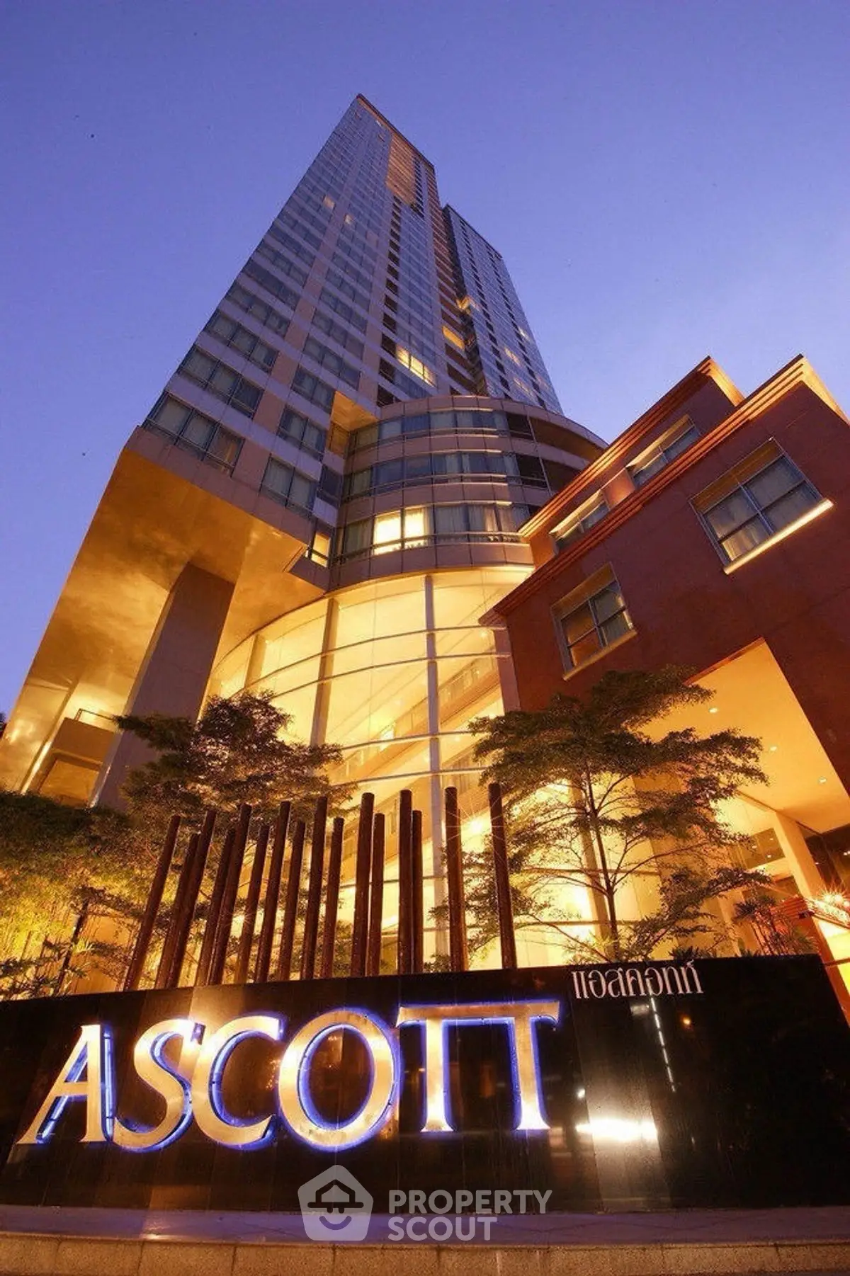 Stunning high-rise building with modern architecture and elegant lighting at dusk.