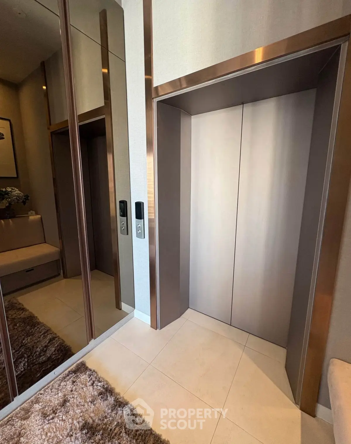 Luxurious modern elevator with mirrored walls and plush carpet in upscale building.