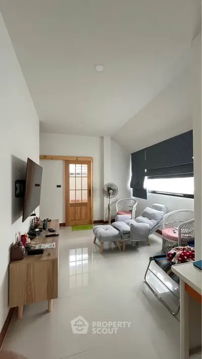Modern living room with stylish furniture and wall-mounted TV