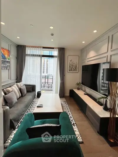 Luxurious living room with modern decor, large TV, and elegant seating in a high-rise apartment.