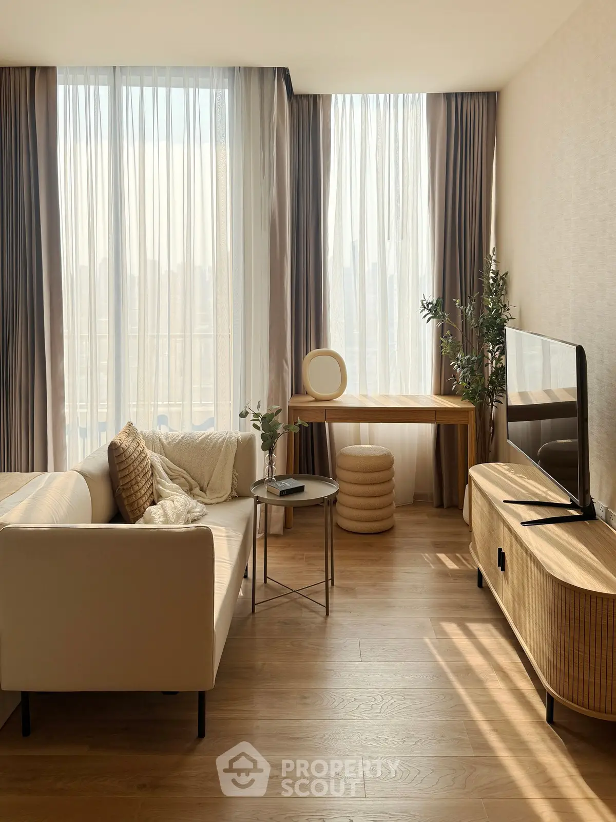 Modern living room with stylish furniture, large windows, and natural light.