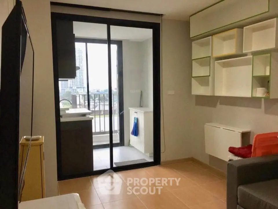 Modern apartment with balcony and stylish shelving, offering a cozy living space with city views.
