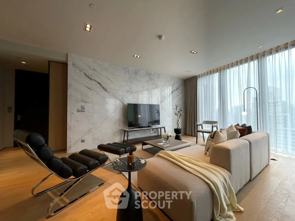 Luxurious modern living room with marble accent wall and floor-to-ceiling windows offering stunning city views.