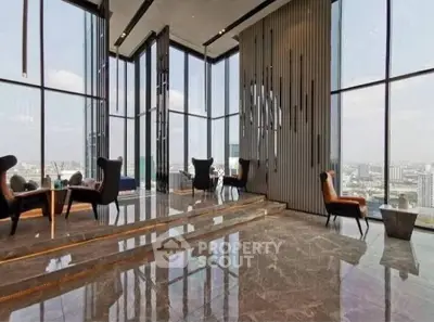 Luxurious high-rise building lobby with panoramic city views and elegant seating.