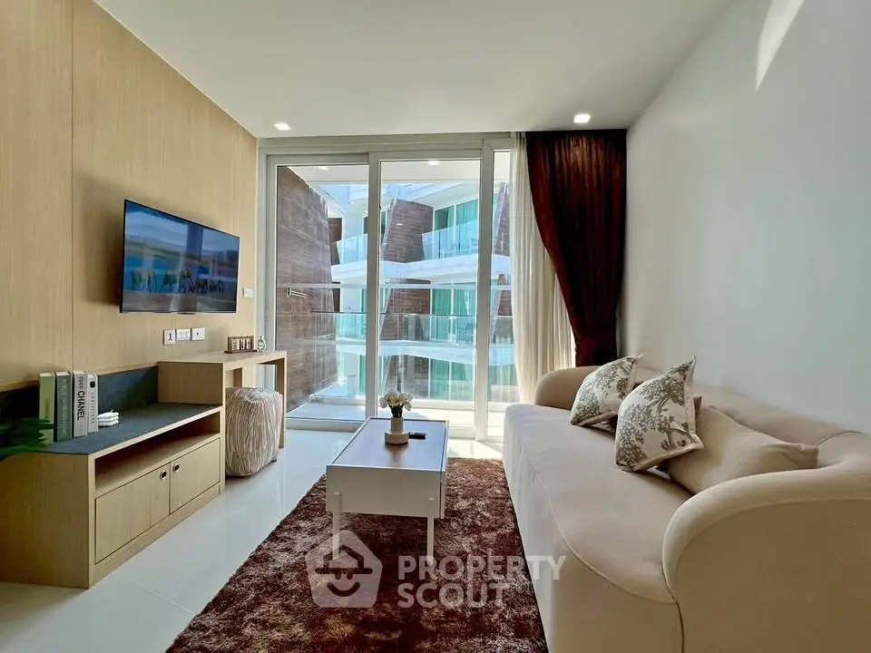 Modern living room with elegant decor and large windows offering a stunning view of the building exterior.