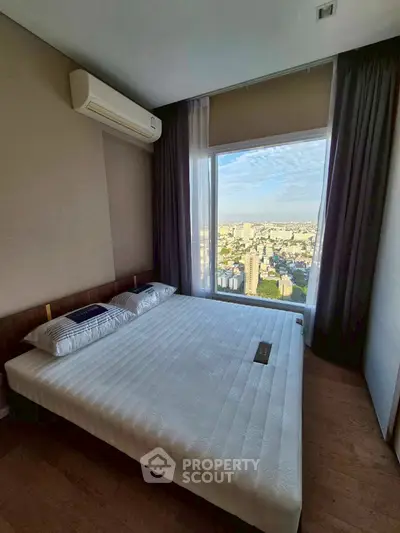 Luxurious bedroom with stunning city view from large window, featuring modern decor and air conditioning.